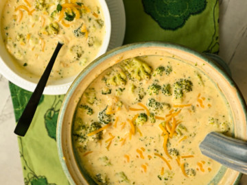 Keto broccoli cheese soup made in a crockpot and served in a green soup tureen and a white bowl