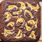 Keto peanut butter swirl brownies on parchment paper