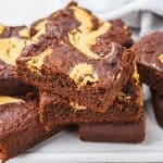 keto peanut butter swirl brownies stacked on a white tray