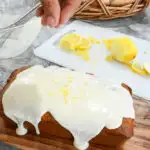 keto lemon pound cake being topped with lemon zest