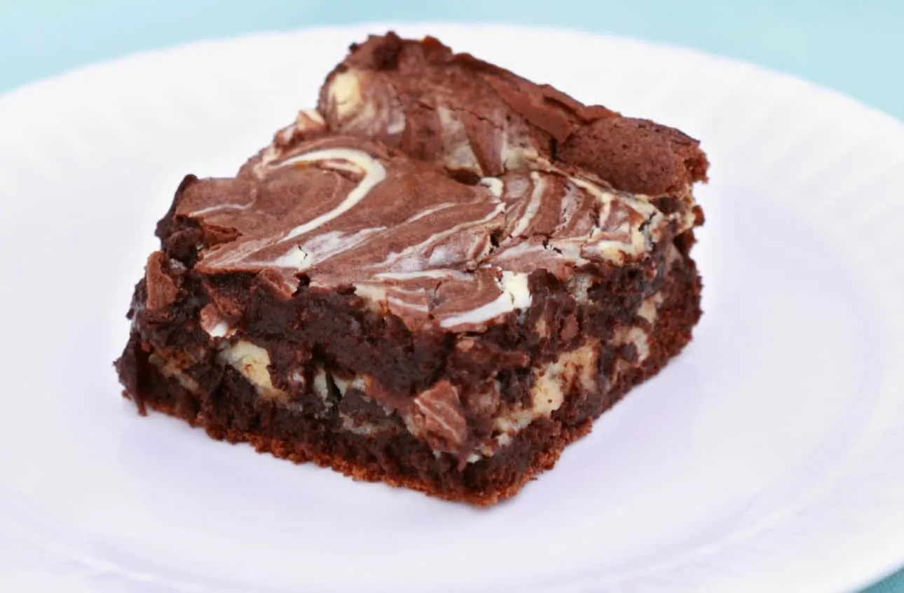 Keto cheesecake swirled brownies to curb your chocolate and cheesecake cravings.