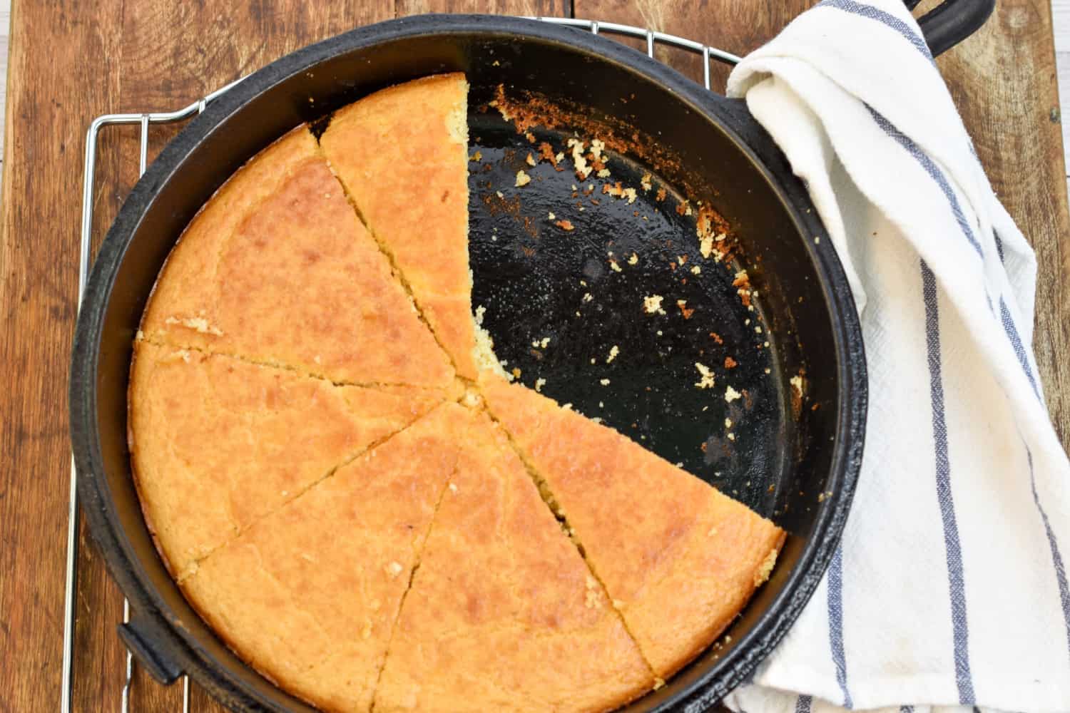 cheto coconut flour cornbread with slices missing in a cast iron skille