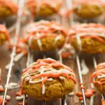 Gluten-free pumpkin cookies on a baking rack allowing the icing to set