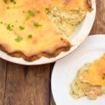 keto chicken pot pie sliced and ready to serve pie is on top of a wood table and pie is served on a white plate