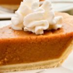 keto pumpkin pie sliced on a white plate