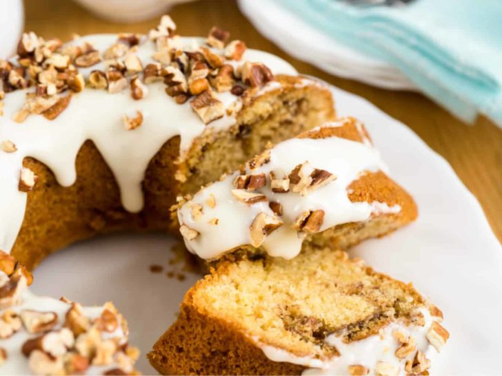 Keto cinnamon cake a bundt cake sliced on a white plate