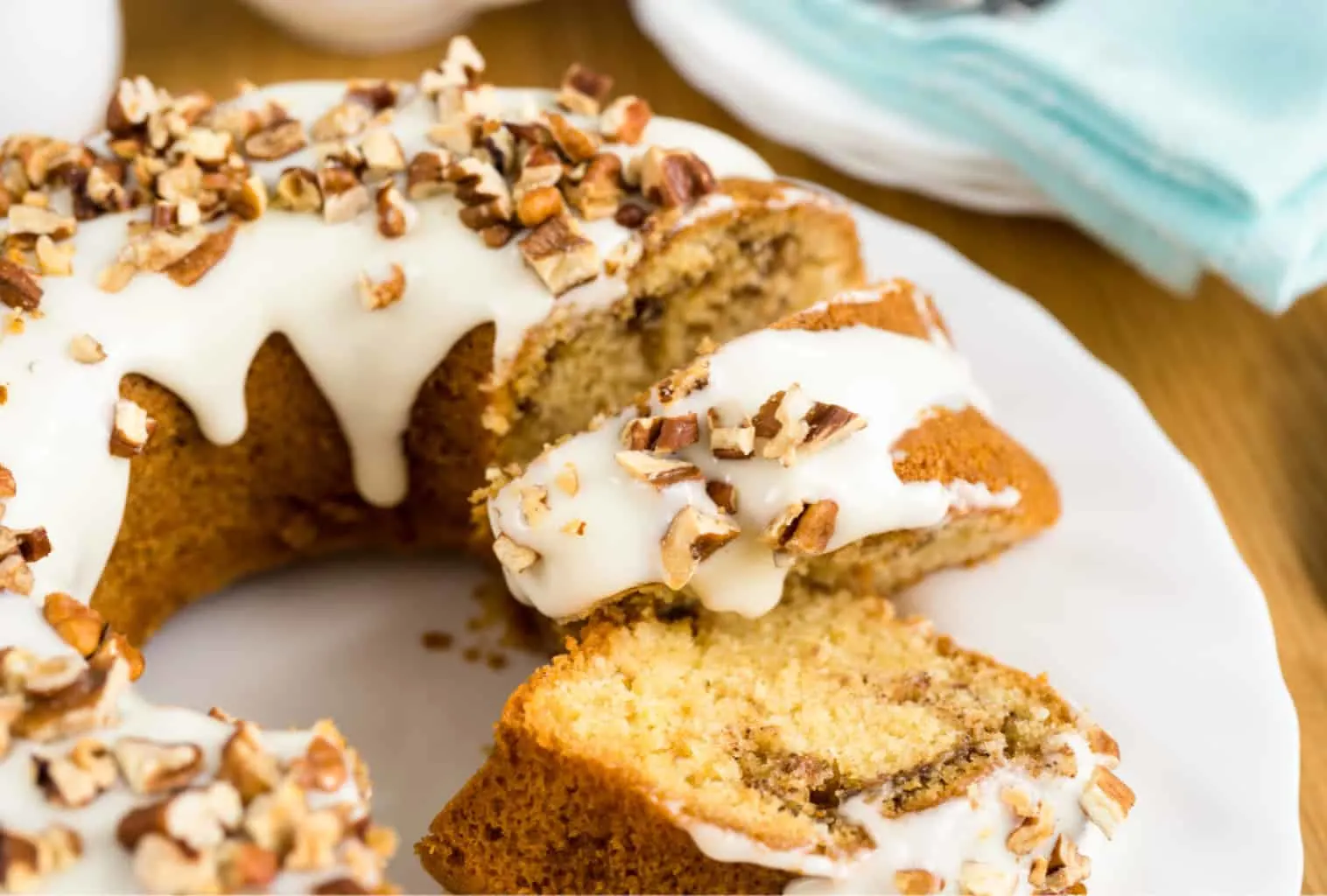 Keto cinnamon cake a bundt cake sliced on a white plate