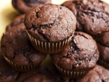 keto cream cheese chocolate muffins piled high close up