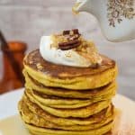 keto pumpkin pancakes topped with cream cheese whipped cream