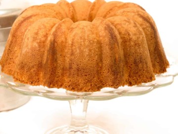 keto sour cream pound cake on a clear cake pedestal stand