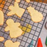 Keto Rolled Sugar Cookies on cooling rack with cookie cutter and icing in background