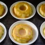 Six keto Cuban flans on a cookie sheet ready to serve