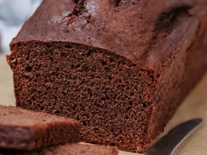 keto bread loaf sliced on parchment paper featured image