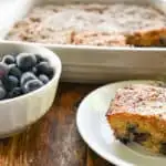 keto blueberry buckle cake with a side of blueberries in a small bowl