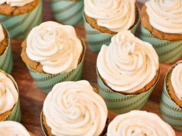 keto carrot cake cupcakes on a wood cake stand