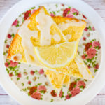 keto lemon ricotta scones with lemon slice on top stacked on pink flower plate