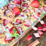 keto strawberry rhubarb topped with vanilla icing in a clear rectangle baking dish