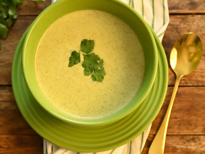 keto cream of broccoli soup served in a green bowl