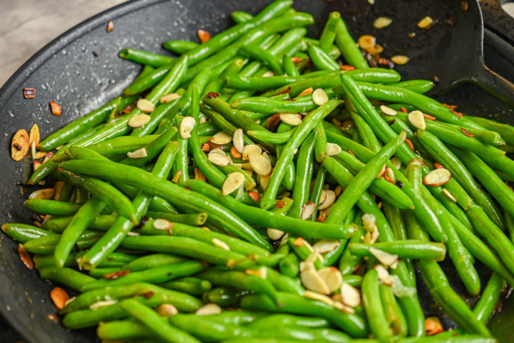 keto green beans almondine in a black skillet