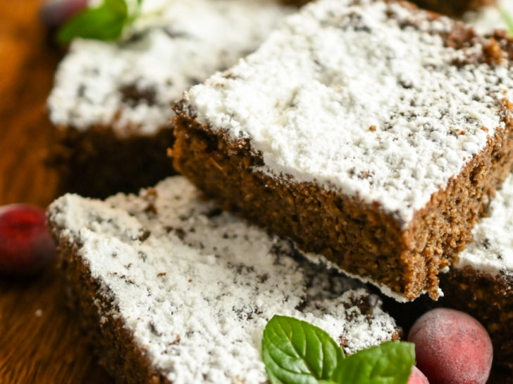 keto gingerbread snack cake sliced on a wooden board