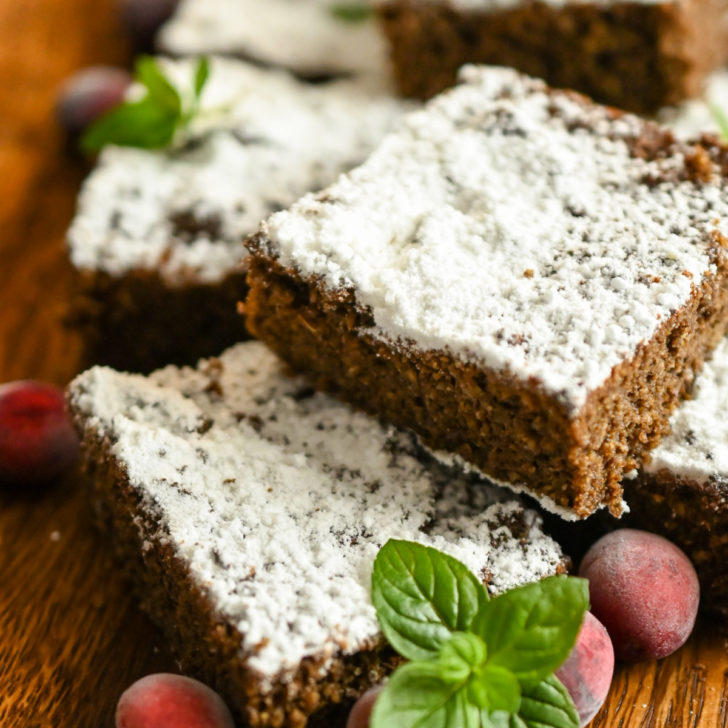 keto gingerbread snack cake sliced on a wooden board