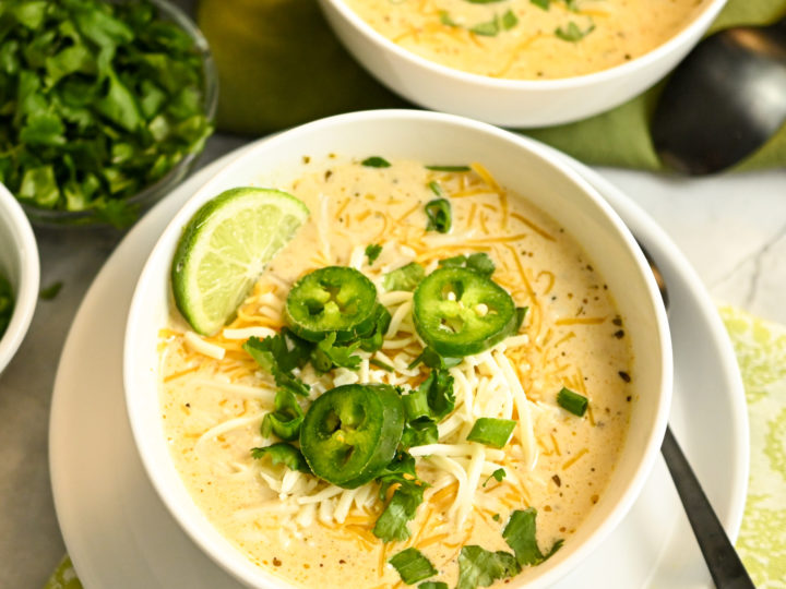 white keto chicken chili served in white bowls