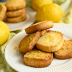 keto lemon shortbread cookies stacked on a small white plate