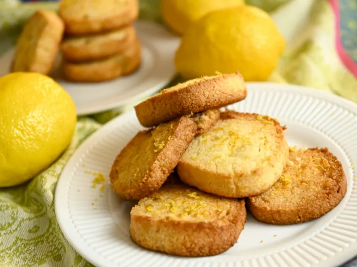 keto lemon shortbread cookies stacked on a small white plate