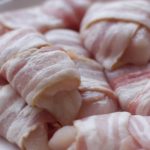 bacon wrapped chicken pieces on a white plate (