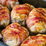 seasoned keto bacon wrapped chicken baked in roasting pan