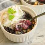 keto blackberry cobbler served in small white ramekins