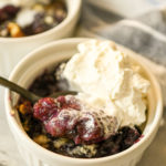 low carb blackberry cobbler served in white ramekins topped with keto vanilla ice cream