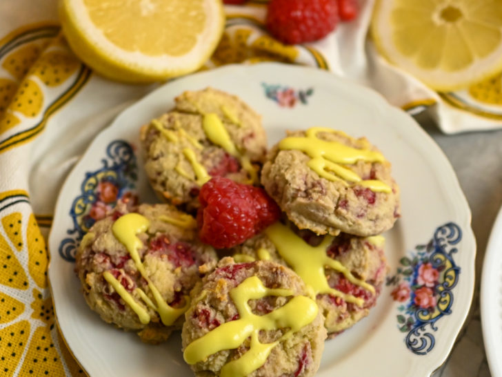 Keto Raspberry Lemonade Cookies served in a small plate with fresh raspberries and lemons as garnish