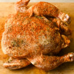 whole cajun chicken seasoned and ready to add to a crockpot