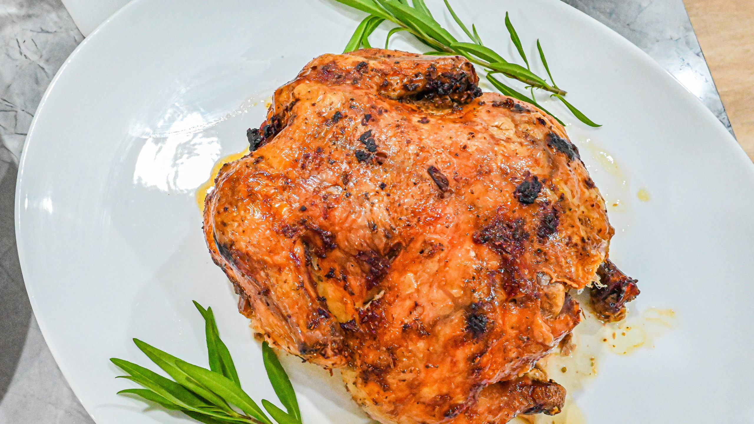 Keto Cuban Mojo Chicken on white plate with herbs