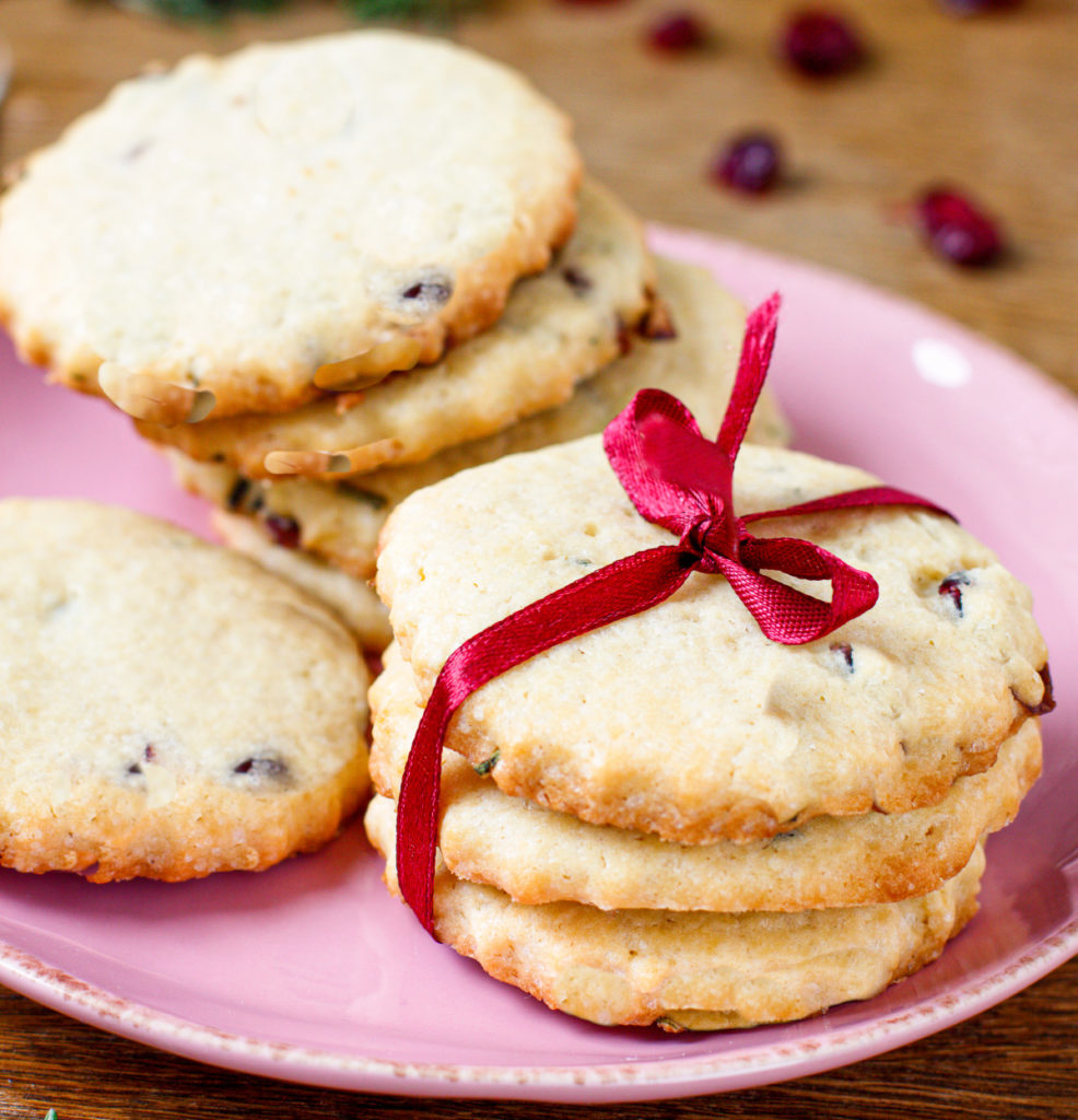 keto cranberry shortbread cookies stacked and tied with a red bow